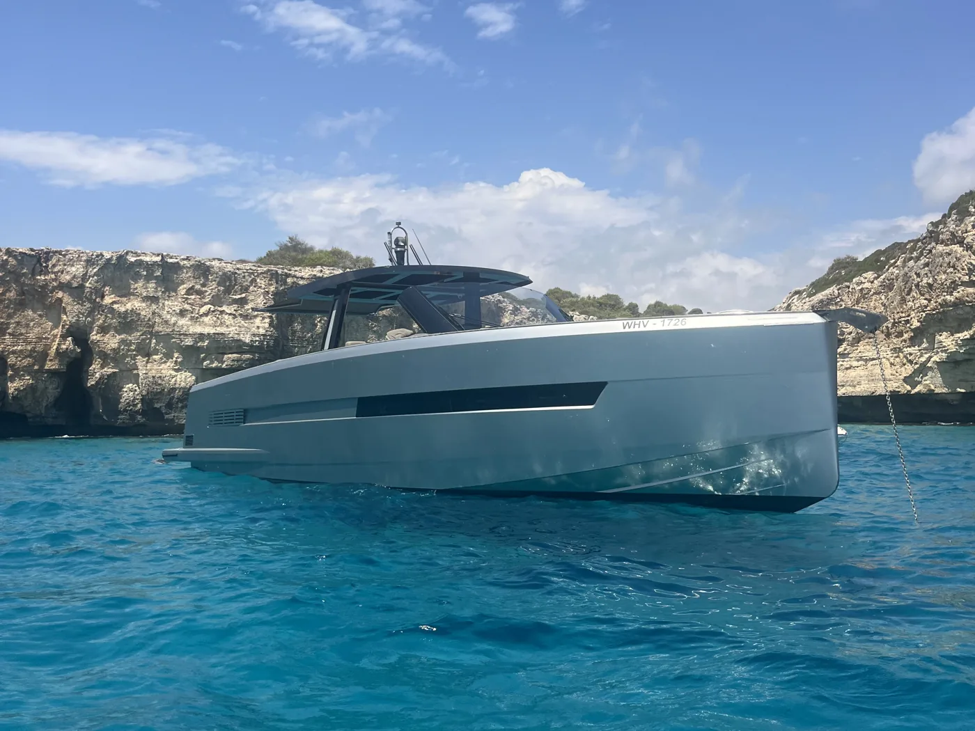 The Fjord 52 “Peanuts” at anchor in a turquoise bay below the cliffs